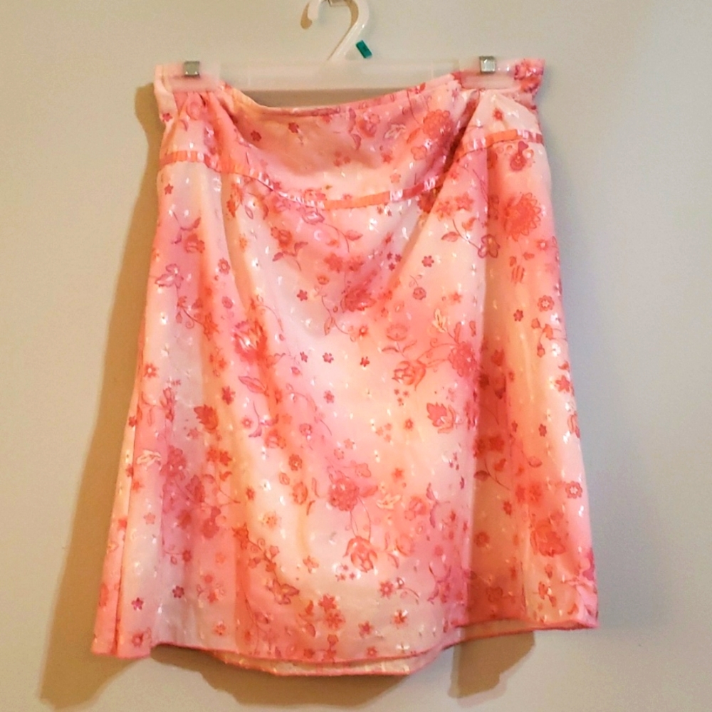 We are selling a pink and white skirt witha flower design made by Exact change.